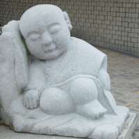 The ISP Column blog preview. A samanera sleeping monk statue.